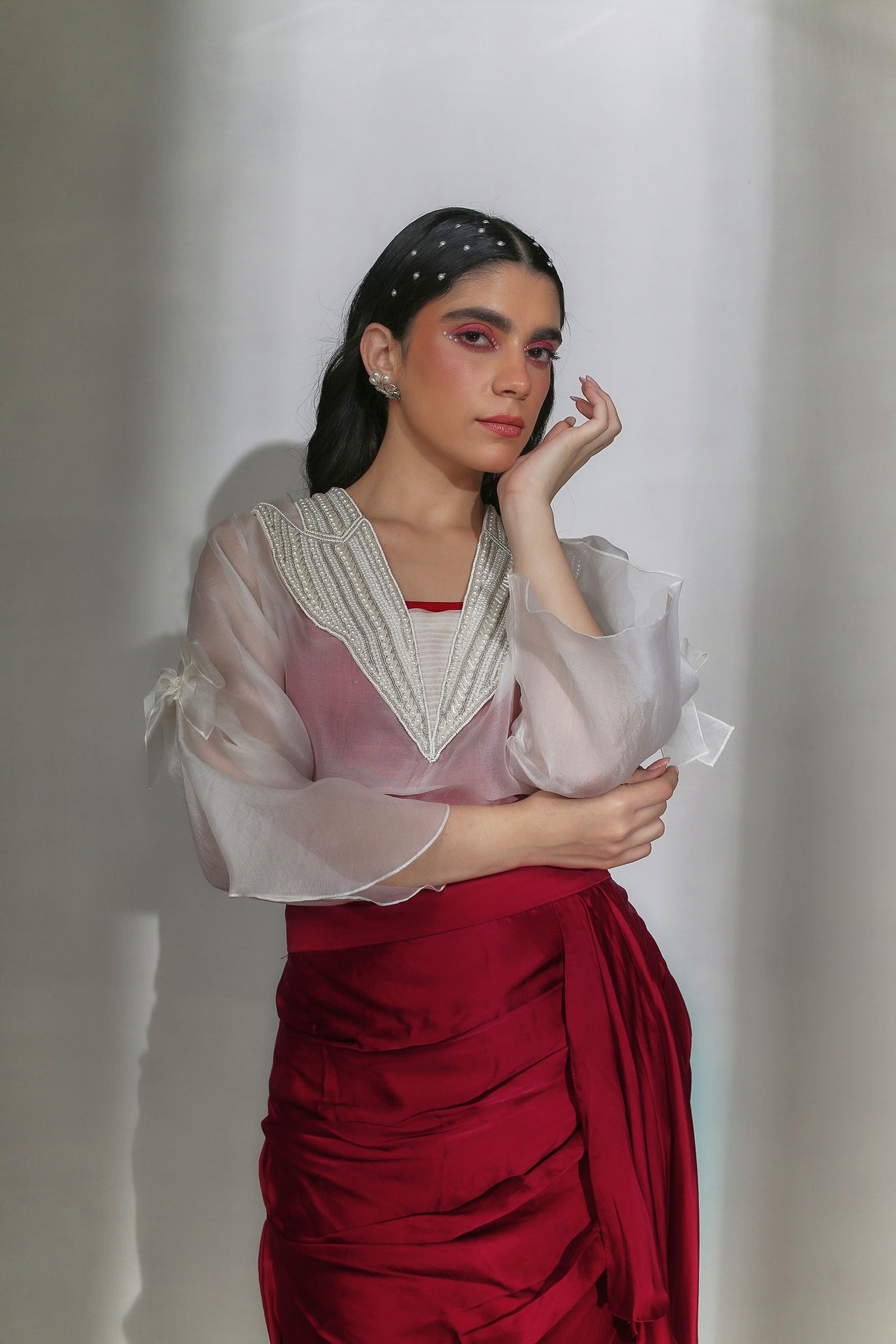 Ezra - Ivory Organza V-Neck Top With Pearl Hand-Embroidery on the Collar & Bows Paired with a Scarlet Red Draped Skirt